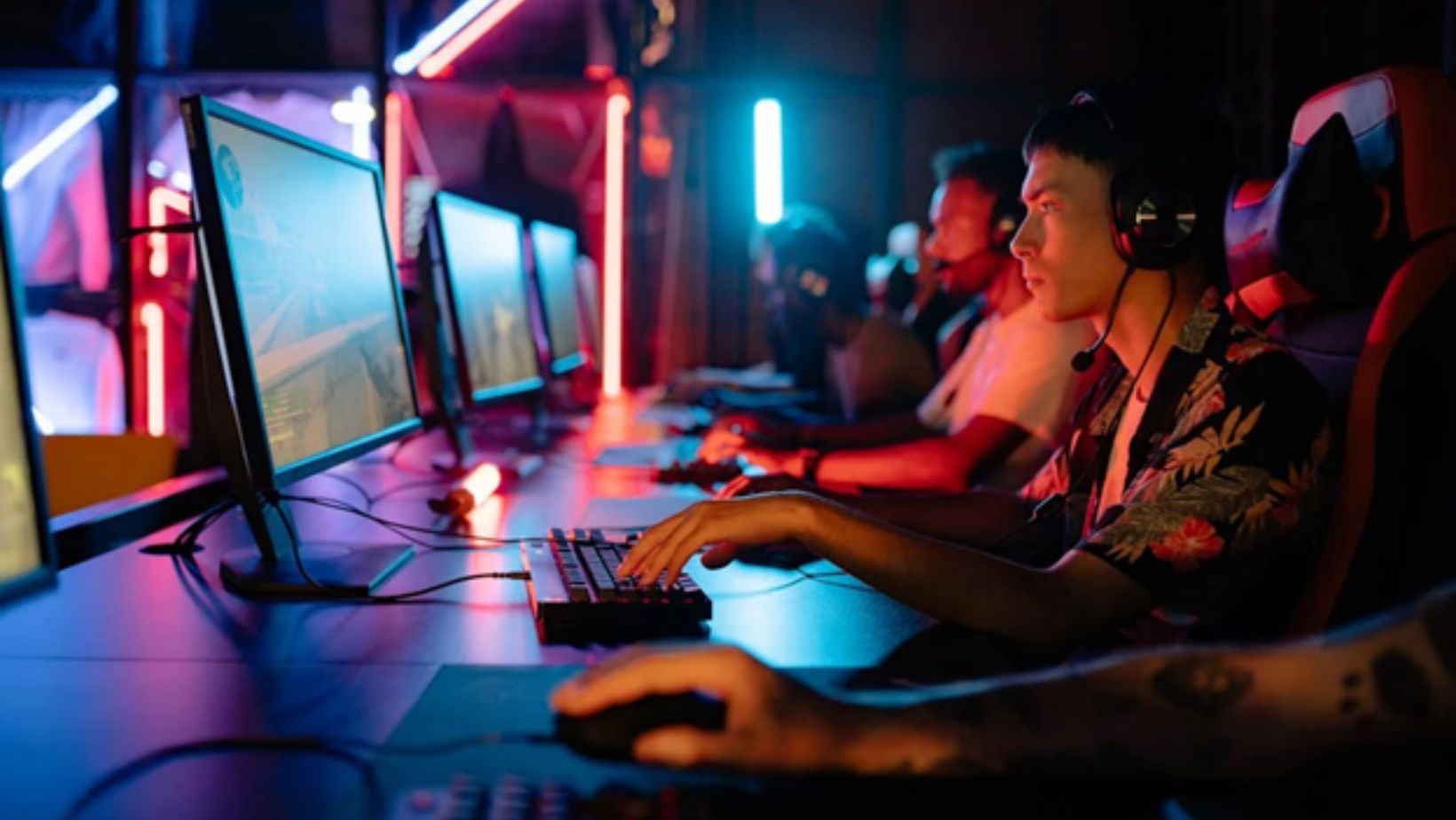 Esports players focused on their game in a neon-lit arena